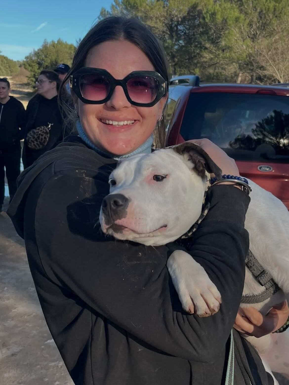 Câlin complice avec un staffie blanc lors d'une balade