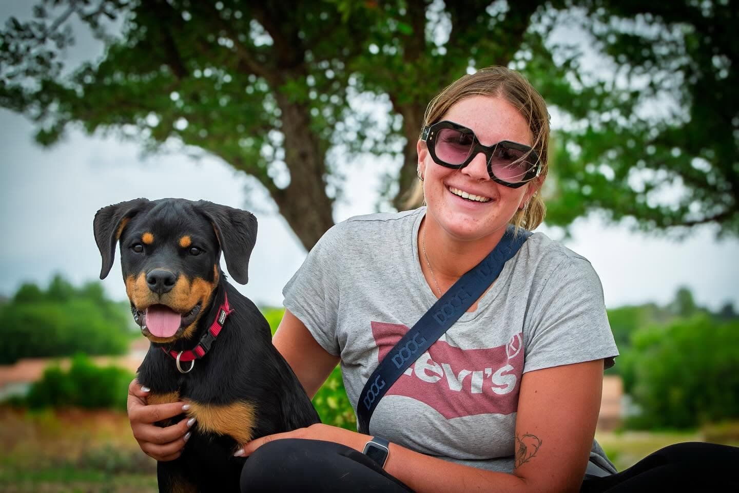Portrait d'un chiot rottweiler avec sa maîtresse